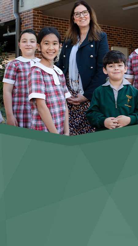 St Patrick's Catholic Primary Parramatta students standing with dedicated principal Mrs Bernadette Fabri