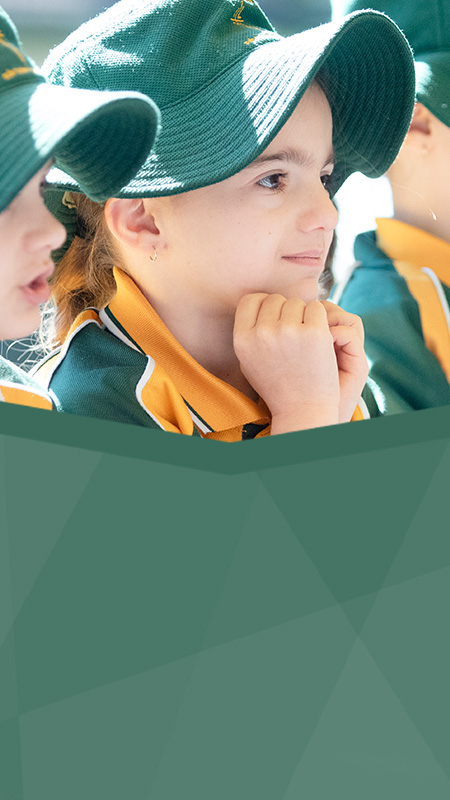 St Patrick's Catholic Primary Parramatta students smiling and sitting in a row