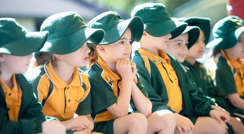 St Patrick's Catholic Primary School Parramatta students sitting on playground
