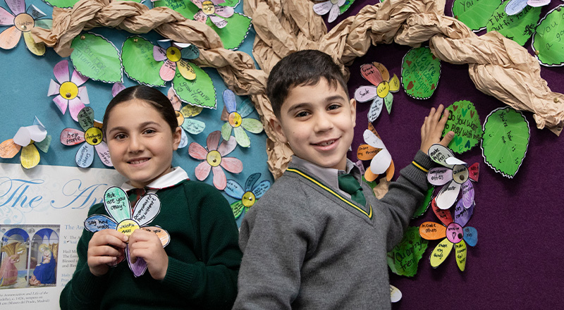 St Patrick's Catholic Primary School Parramatta students standing in front of wellbeing tree