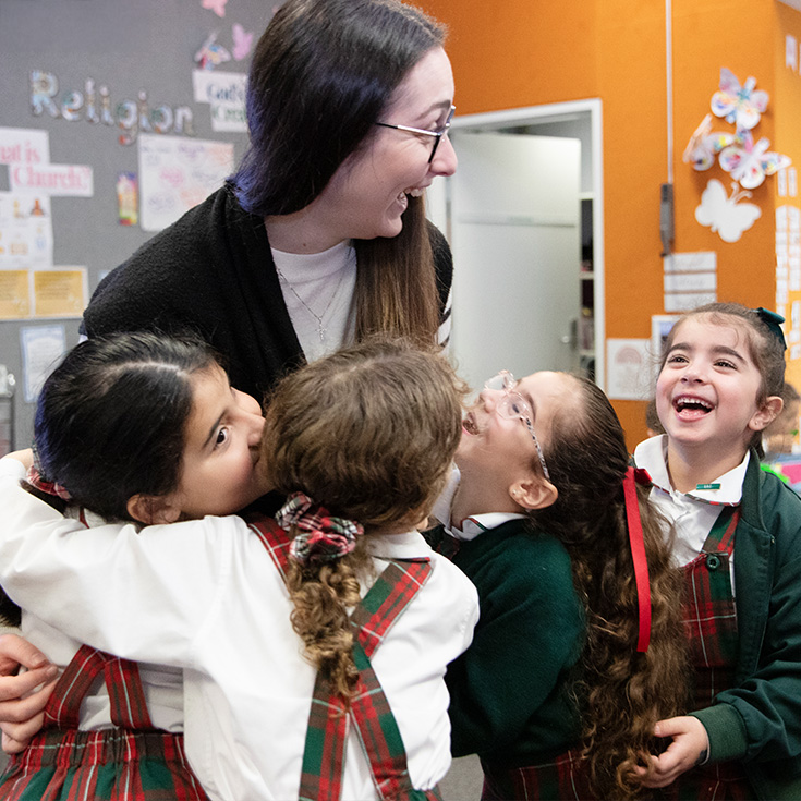 St Patrick's Catholic Primary School Parramatta students hugging a dedicated teacher
