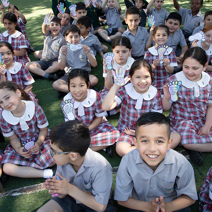 St Patrick's Catholic Primary School Parramatta students sitting on playground
