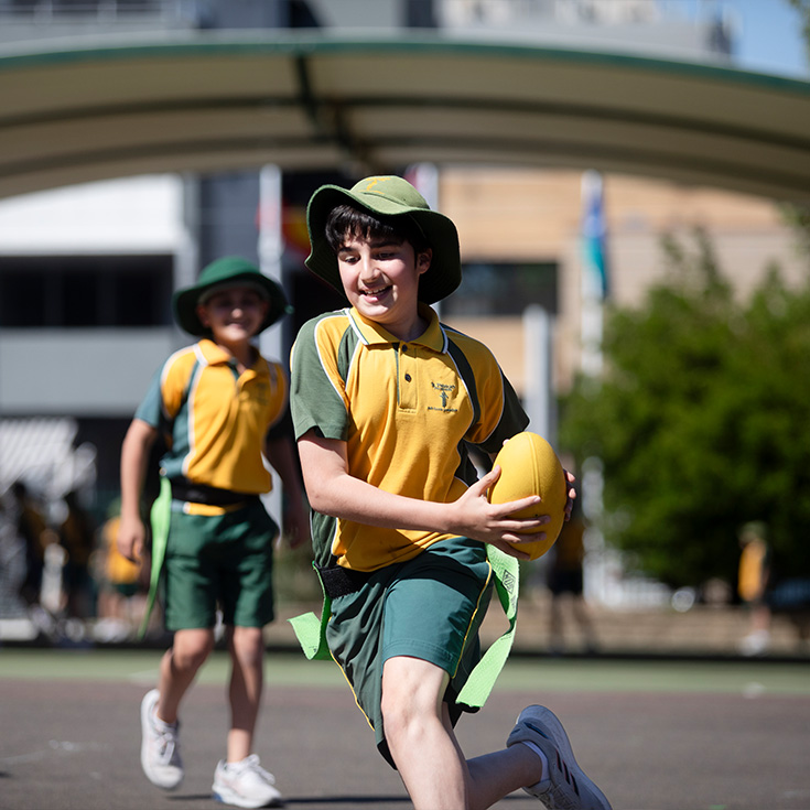 St Patrick's Catholic Primary School Parramatta student playing touch footy